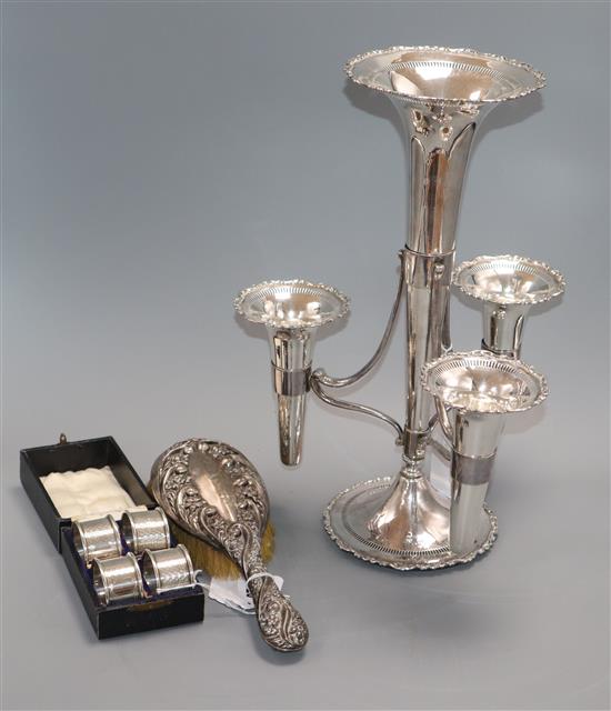 A plated four-trumpet epergne, a set of four silver napkin rings, cased and a silver-mounted brush epergne 38cm